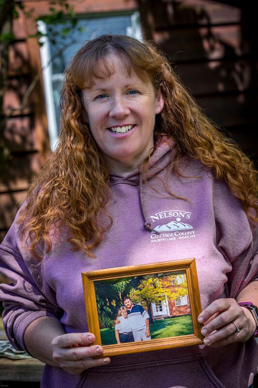 julie nelson holding a photo of her mother and stepfather
