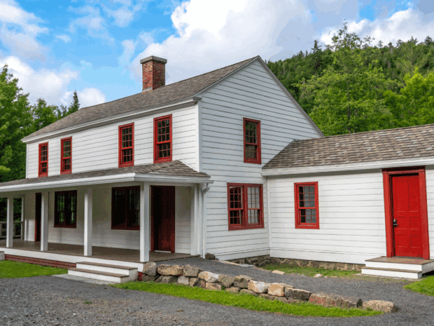 White cottage with red shutters