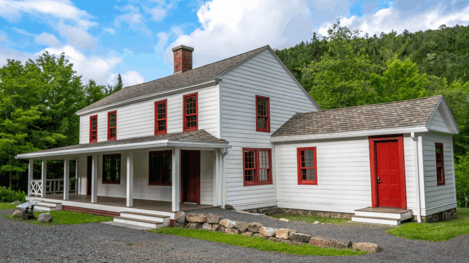 White cottage with red shutters