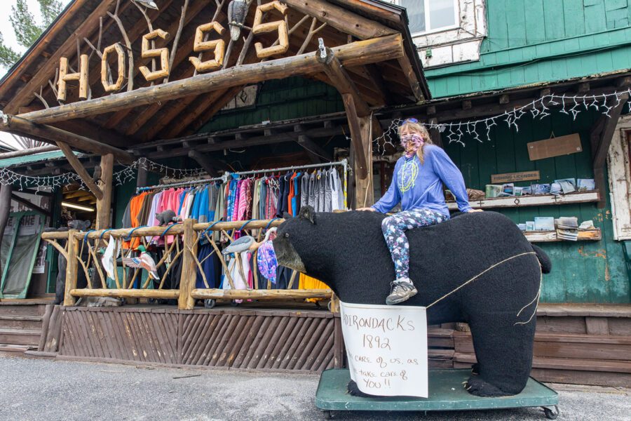 Jules Pierce, store manager at Hoss’s Country Corner in Long Lake, poses in front of her shop on a Saturday morning in late May. 