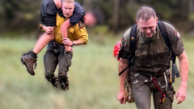 Ranger Lewis carries the patient to the helicopter at Elk Pass.
