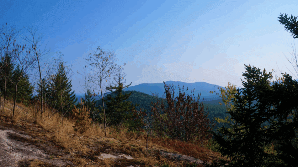 View looking out from mountain to blue peak