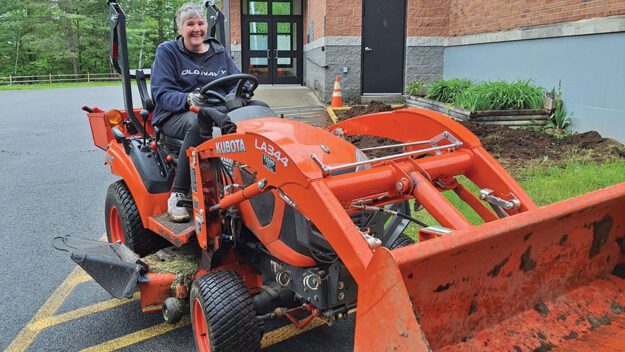 woman driving a backhoe loader