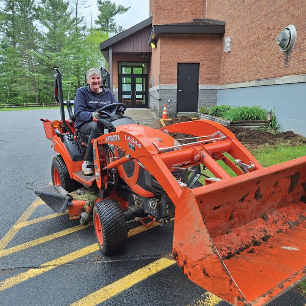 woman driving a backhoe loader