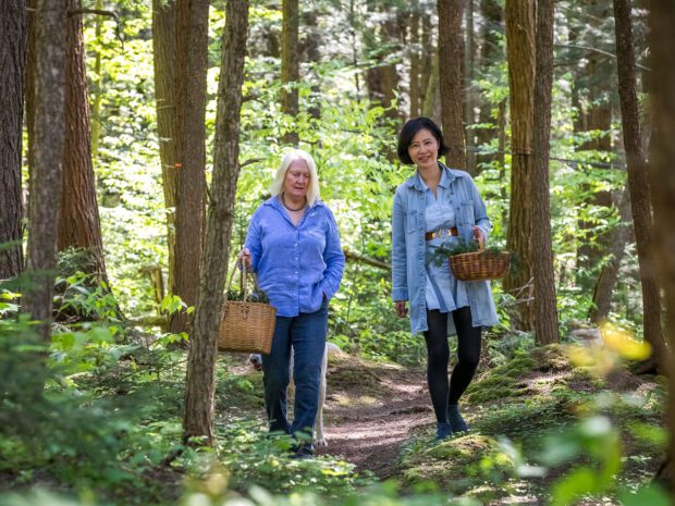 two women of adirondack fragrance farm walking in the woods