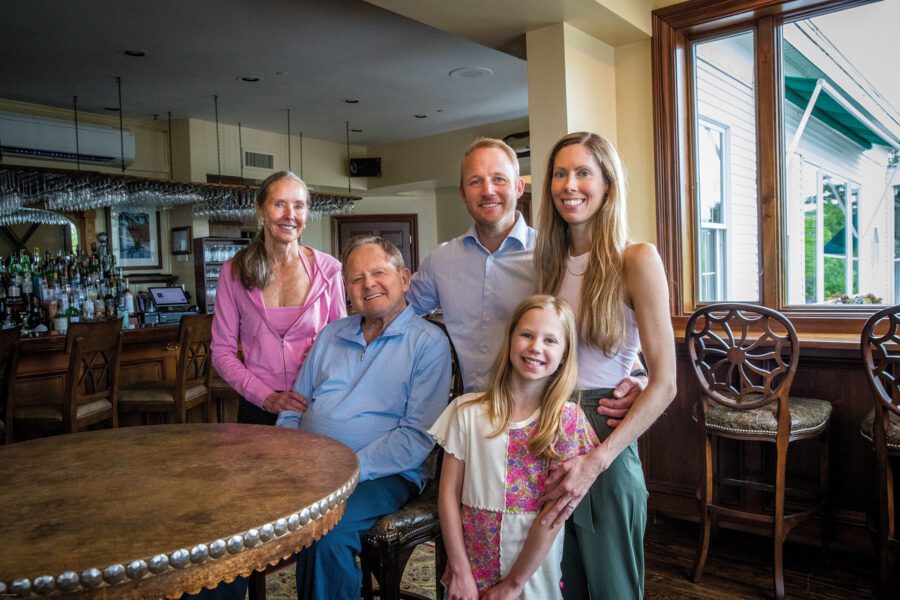 The Mirror Lake Inn in Lake Placid NY is a generational family business. Gathered in the pub are L-R: Lisa Weibrecht, her husband Ed, their son Andrew, his wife Denja and their young daughter Adalina.