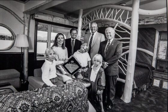 The Mirror Lake Inn in Lake Placid NY is a generational family business.This photo is from the 1990s. Lisa and Ed Weibrecht with their young sons Andrew, Jonathan and Ethan posing with a AAA Award presented to them by the AAA (2 men on right).  photo by Nancie Battaglia