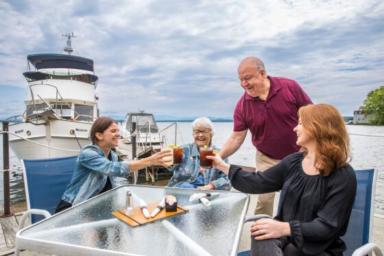 family sitting around a table outside at the Portside