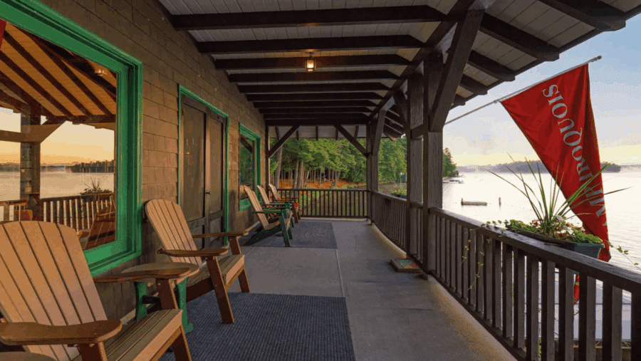 Lakeside porch at Camp Iroquois in Saranac Lake. Photo by Jordan Craig, courtesy of Platinum Luxury Auctions