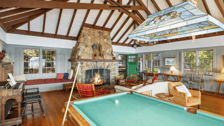 Fireplace Great room with pool table vaulted tudor ceilings Camp Iroquois in Saranac Lake. Photo by Jordan Craig, courtesy of 