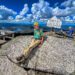 man sitting on a rock at the top of a mountain in the Adirondacks