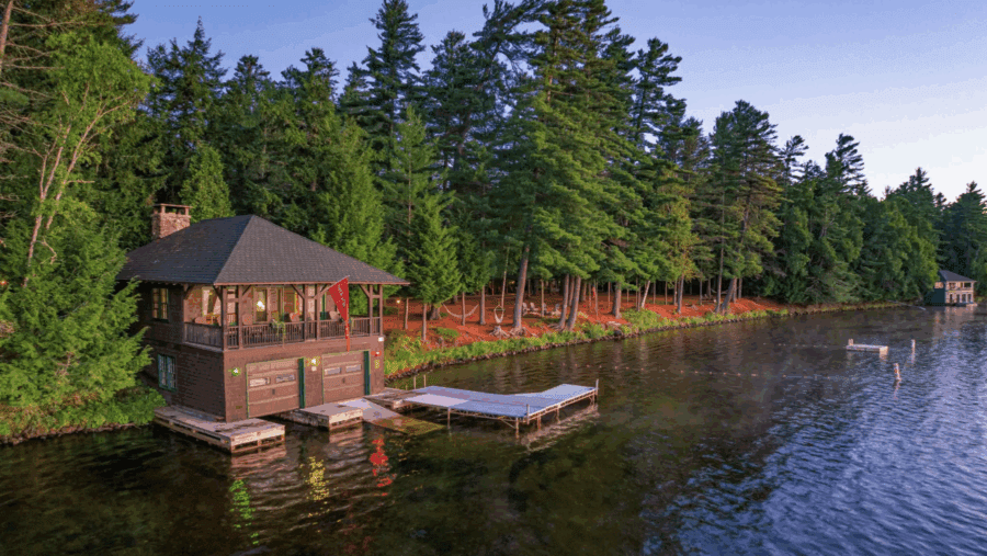 Boathouse with pine trees at Camp Iroquois in Saranac Lake is a historic 4,000-square-foot Great Camp nestled on 8.6 secluded, wooded acres. Currently listed for $4.25 million, the property is being auctioned on Sept. 23 without reserve.

Jordan Craig/Platinum Luxury Auctions
