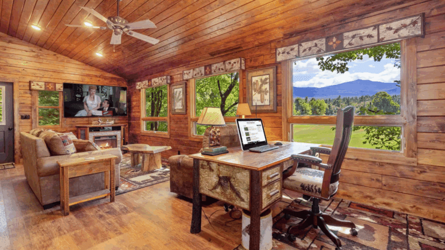 Inside cabin living room with I Love Lucy on TV and desk in the foreground